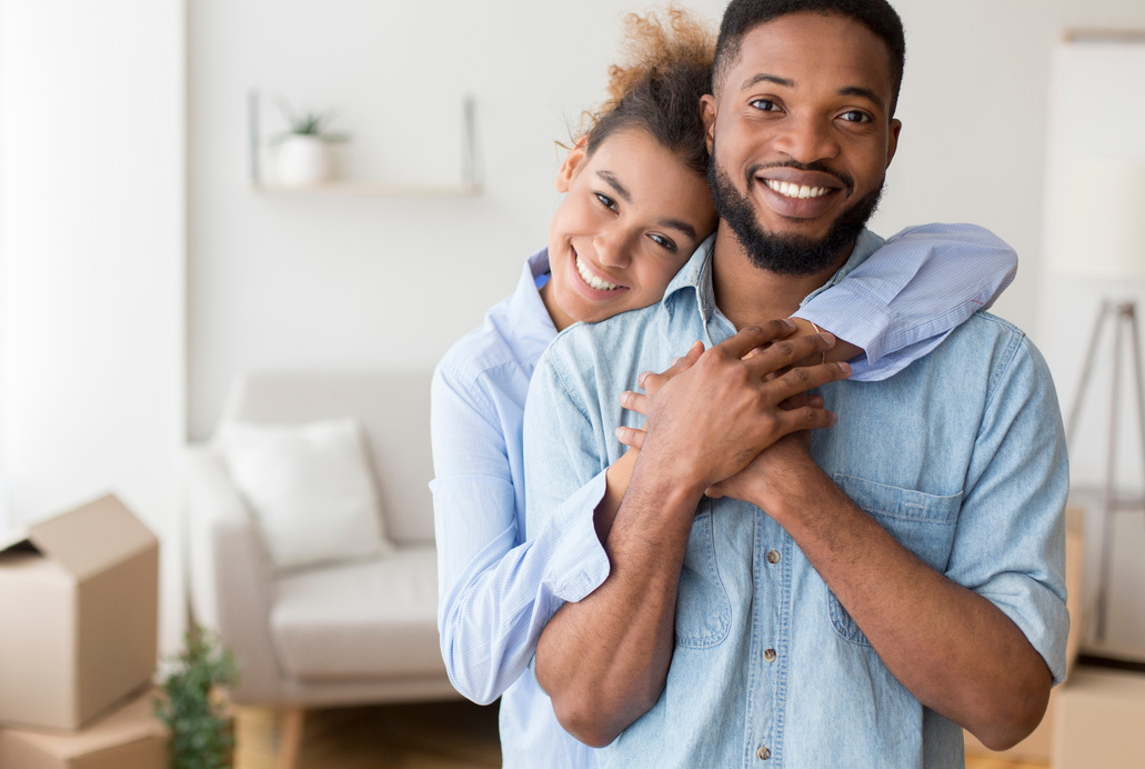 Black Couple Hugging Standing In New Apartment